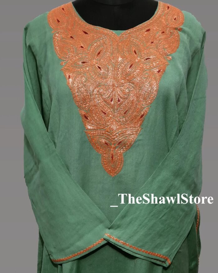 1000063523 6 <strong>Indulge in Elegance with The Shawl Store’s 42 Count </strong><strong>Kashmiri Tilla Pheran</strong> Immerse yourself in the opulence of our 42 Count Tilla Pheran from The Shawl Store. This exquisite piece of craftsmanship showcases the intricate beauty of traditional Kashmiri embroidery, harmoniously blending tradition and luxury. Meticulously handwoven using the finest quality fabrics, this pheran effortlessly drapes over your shoulders, enveloping you in sheer elegance. Elevate any ensemble with the soft, supple touch of this luxurious shawl, a testament to timeless style and refined taste.