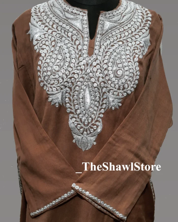 1000064089 2 <strong>Indulge in Elegance with The Shawl Store’s 42 Count Tilla Embroidery Pheran</strong> Immerse yourself in the opulence of our 42 Count Tilla Pheran from The Shawl Store. This exquisite piece of craftsmanship showcases the intricate beauty of traditional Kashmiri embroidery, harmoniously blending tradition and luxury. Meticulously handwoven using the finest quality fabrics, this pheran effortlessly drapes over your shoulders, enveloping you in sheer elegance. Elevate any ensemble with the soft, supple touch of this luxurious shawl, a testament to timeless style and refined taste.