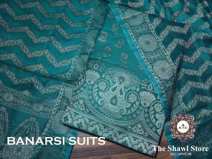 1000070221 Delve into the realm of unmatched grandeur with the enchanting banarsi silk suits by The Shawl Store. Immerse yourself in a world of regal sophistication as you drape these resplendent ensembles, meticulously handwoven by master artisans. Crafted from premium banarsi silk, each suit is a masterpiece, showcasing intricate zari work that weaves a tapestry of utter magnificence. The lustrous fabric gracefully skims your silhouette, enveloping you in a cocoon of pure luxury. Experience the fusion of heritage and contemporary design, exuding an aura of regality. Unleash your inner queen and conquer the world of fashion with The Shawl Store’s banarsi silk suits.