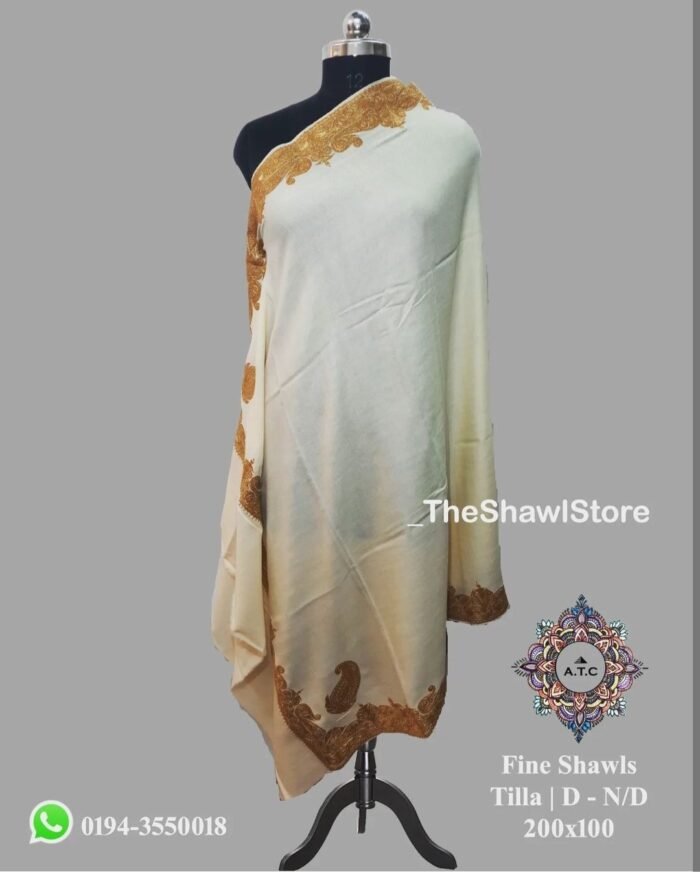 1000074316 <h3><strong><em>Experience Timeless Beauty and Unparalleled Craftsmanship with The Shawl Store’s Kashmiri Tilla Embroidery Woolen Shawl</em></strong></h3> Be captivated by the allure of our Kashmiri Tilla Embroidery Woolen Shawl, meticulously crafted to perfection and exclusively available at The Shawl Store. Imbued with the expertise of skilled artisans, this masterpiece showcases the mesmerizing beauty of Kashmiri embroidery. The intricate Tilla work adorns the plush wool, exuding an air of elegance and rarity. Wrap yourself in sheer luxury as you embrace the warmth and softness of this shawl, symbolizing the pinnacle of sophistication. Elevate your ensemble to new heights of grandeur with this extraordinary creation from The Shawl Store.