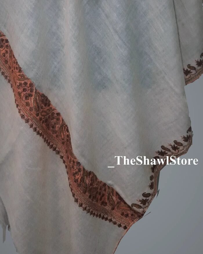 1000076273 Discover the epitome of luxury with our handcrafted Pashmina Stole adorned with mesmerizing Sozni Embroidery, now presented at The Shawl Store. Immerse yourself in the sheer elegance and richness of our artisanal creations that carefully combine the plushness of Pashmina wool with the unparalleled artistry of Sozni embroidery. Draped around your shoulders, these stoles offer the perfect blend of warmth, comfort, and style. Delight in the masterful expertise of our craftsmen and embrace the allure of these exceptional pieces, available exclusively at The Shawl Store.