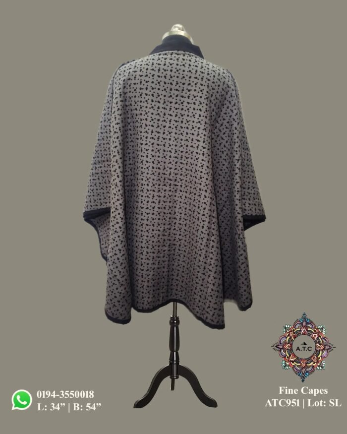 1000077865 Wrap yourself in luxurious warmth with the Women Cape Coat by The Shawl Store. Made from the finest fabrics and detailed with exquisite craftsmanship, this cape coat is a must-have addition to your outerwear collection. Whether worn for a night out on the town or a formal event, this coat will ensure you make a lasting impression.