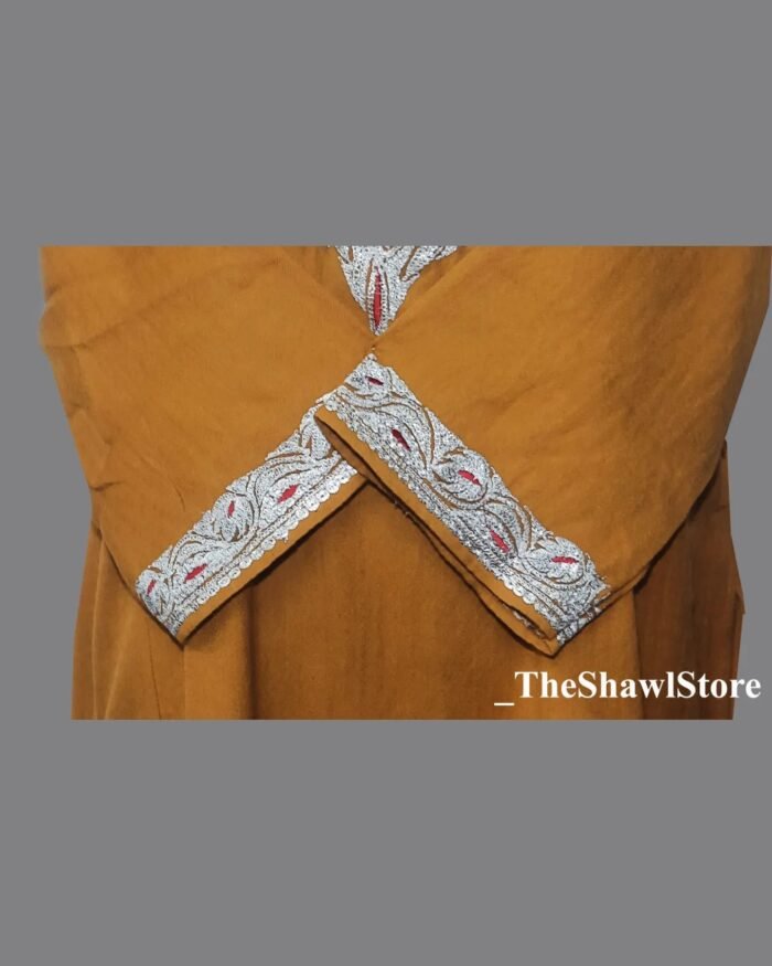 1000078172 <strong>Indulge in Elegance with The Shawl Store’s 42 Count Tilla Embroidery Pheran</strong> Immerse yourself in the opulence of our 42 Count Tilla Embroidery Kashmiri Pheran from The Shawl Store. This exquisite piece of craftsmanship showcases the intricate beauty of traditional Kashmiri embroidery, harmoniously blending tradition and luxury. Meticulously handwoven using the finest quality fabrics, this pheran effortlessly drapes over your shoulders, enveloping you in sheer elegance. Elevate any ensemble with the soft, supple touch of this luxurious shawl, a testament to timeless style and refined taste.