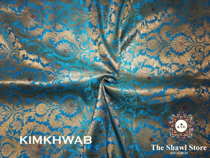 IMG 20240330 193938 093 Indulge in the timeless beauty of Pure Silk Kimkhab Fabric, exclusively available at The Shawl Store. Crafted from the finest silk, this Brocade Banarasi fabric boasts a rich texture and intricate brocade work that is sure to make a statement. Whether for a special occasion or everyday wear, this luxurious fabric is a must-have for any fashion enthusiast. <strong><em>Quantity: </em></strong><em>1 Piece/Unit = 1 Metre</em>