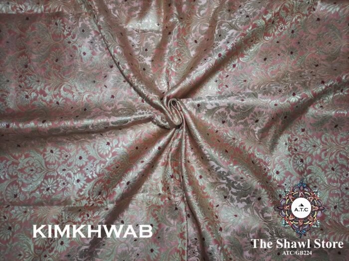 1000085687 Indulge in the timeless beauty of Pure Silk Kimkhab Fabric, exclusively available at The Shawl Store. Crafted from the finest silk, this Brocade Banarasi fabric boasts a rich texture and intricate brocade work that is sure to make a statement. Whether for a special occasion or everyday wear, this luxurious fabric is a must-have for any fashion enthusiast. <strong><em>Quantity: </em></strong><em>1 Piece/Unit = 1 Metre</em>