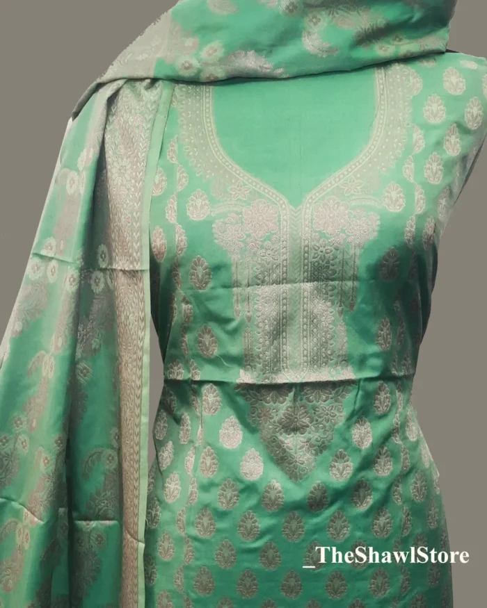 IMG 20240616 140657 406 Delve into the realm of unmatched grandeur with the enchanting Shiny Silver Salwar Suit - Silk Kurta Set with Dupatta for Women by The Shawl Store. Immerse yourself in a world of regal sophistication as you drape these resplendent ensembles, meticulously handwoven by master artisans. Crafted from premium banarsi silk, each suit is a masterpiece, showcasing intricate Zari work that weaves a tapestry of utter magnificence. The lustrous fabric gracefully skims your silhouette, enveloping you in a cocoon of pure luxury. Experience the fusion of heritage and contemporary design, exuding an aura of regality. Unleash your inner queen and conquer the world of fashion with The Shawl Store’s Silk Suits.